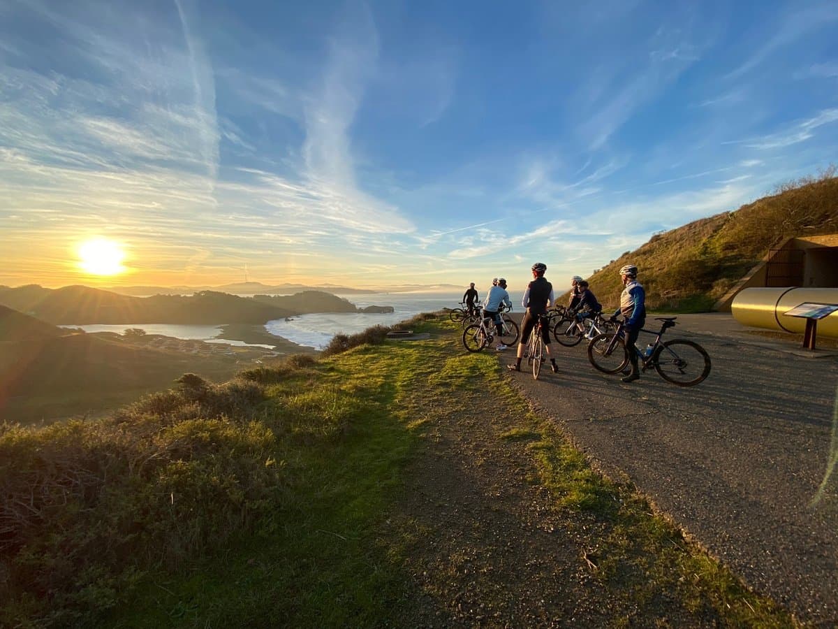 Riders descending Hawk Hill with views of the bay